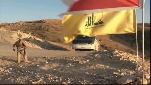 militants leave Hezbollah flag