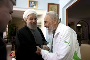 Cuba's former leader Fidel Castro, right, shakes hands with Iranian President Hassan Rouhani, center, in Havana, Cuba, Monday, Sept 19, 2016. Rouhani is on a one-day official visit to Cuba. (AP Photo/Alex Castro)