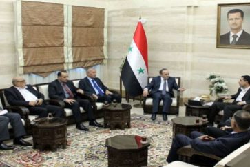 Syrian Prime Minister Imad Khamis receiving Lebanese Industry Minister Hussein al-Hajj Hassan