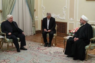 Iranian President Sheikh Hassan Rouhani receiving Syrian Foreign Minister Walid al-Moallem in Tehran