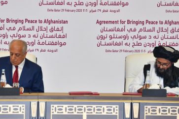 (L to R) US Special Representative for Afghanistan Reconciliation Zalmay Khalilzad and Taliban co-founder Mullah Abdul Ghani Baradar sign a peace agreement during a ceremony in the Qatari capital Doha on February 29, 2020. - The United States signed a landmark deal with the Taliban, laying out a timetable for a full troop withdrawal from Afghanistan within 14 months as it seeks an exit from its longest-ever war. (Photo by Giuseppe CACACE / AFP) (Photo by GIUSEPPE CACACE/AFP via Getty Images)