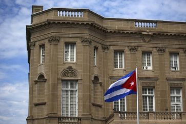 The Cuban national flag is seen raised over their new embassy in Washington July 20, 2015. REUTERS/Carlos Barria/Files