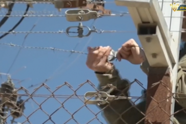 Zionist soldier repairing border fence off Lebanese Houla town