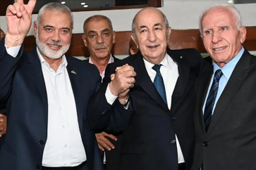 Algerian President Abdelmadjid Tebboune (C) poses with Hamas leader Ismail Haniyeh and Fatah member Azzam al-Ahmad (R) - Algerian Presidency's Facebook page/AFP