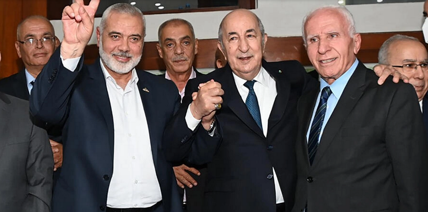 Algerian President Abdelmadjid Tebboune (C) poses with Hamas leader Ismail Haniyeh and Fatah member Azzam al-Ahmad (R) - Algerian Presidency's Facebook page/AFP