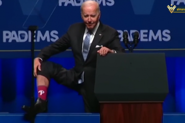 US President Joe Biden showing his sock during a public address