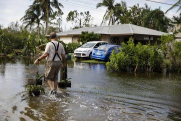 A resident walks home in the aftermath of September’s Hurricane Ian in Fort Myers, Florida.Photographer: Eva Marie Uzcategui/Bloomberg