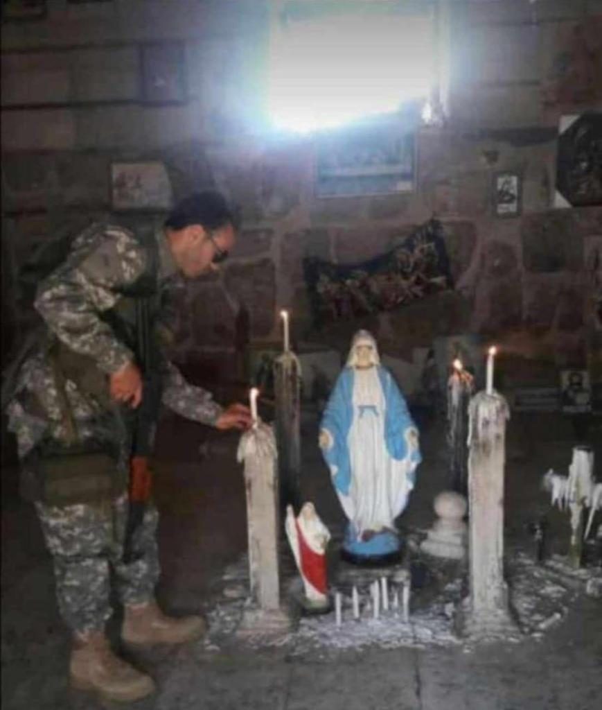 Martyr Ahmad Ali Kassas lightning a candle inside one of Maaloula churches