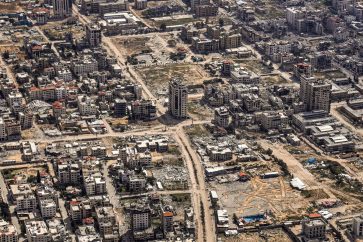 The Star of David is etched in an empty lot surrounded by destroyed buildings in the Gaza Strip, as seen from the US Air Force 26th Expeditionary Rescue Squadron HC-130J aircraft during an airdrop mission of humanitarian aid supplied by Jordan, on March 14, 2024, amid the ongoing conflict between Israel and the Palestinian Hamas movement. (Photo by Dylan COLLINS / AFP)