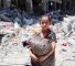 A Palestinian carries some salvaged belongings in the Jabalia refugee camp in the northern Gaza Strip after she returned briefly with others who sought to check on their homes on May 31, 2024, amid the ongoing conflict between Israel and the militant group Hamas. (Photo by Omar AL-QATTAA / AFP)