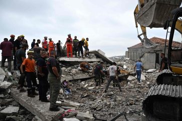 Lebanese civil defence workers clear debris at the site of an Israeli airstrike on the Mount Lebanon village of Maaysra, east of the coastal town of Byblos, on October 12, 2024. (Photo by JOSEPH EID / AFP)