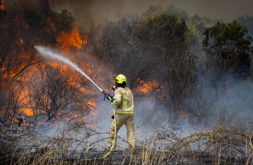 Firefighter trying to extinguish a fire in occupied Al-Quds